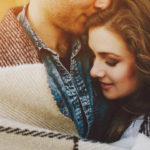 A beautiful woman is being hugged